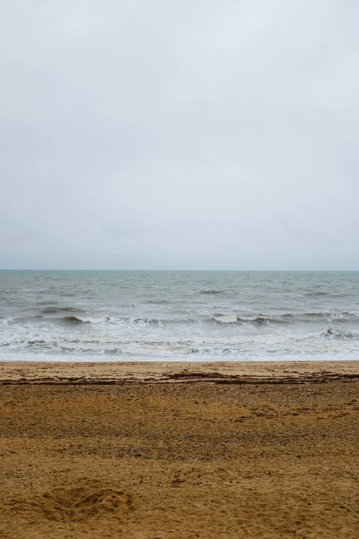 a person standing on the beach near the water