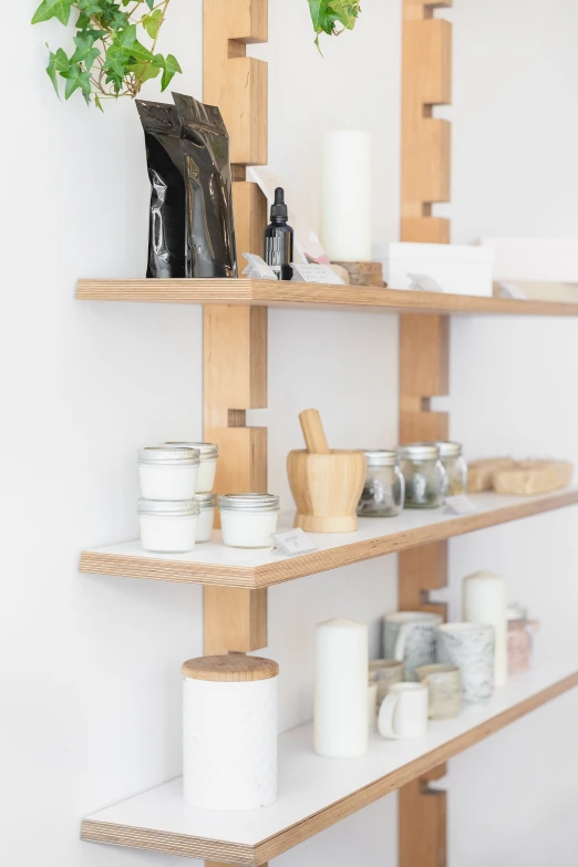 a shelf that has different types of candles on it