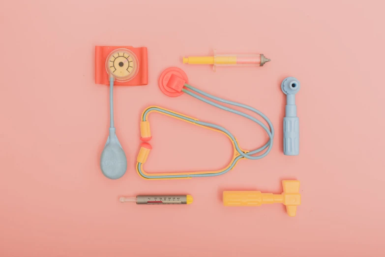 an assortment of toy toys arranged on a pink background