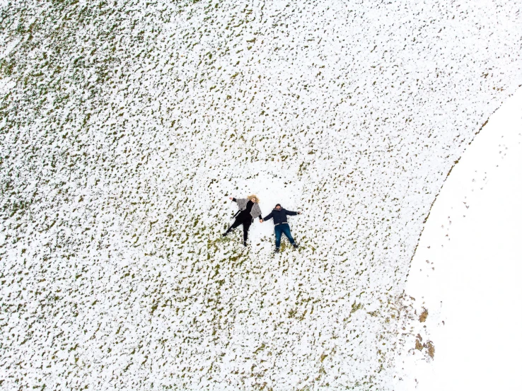 two people walk together through the snow in winter