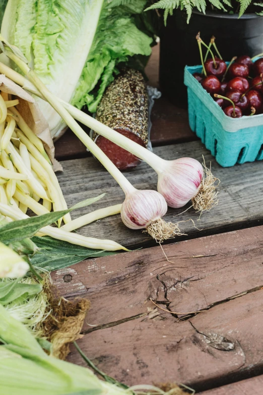 several fruits and vegetables are on a wooden table