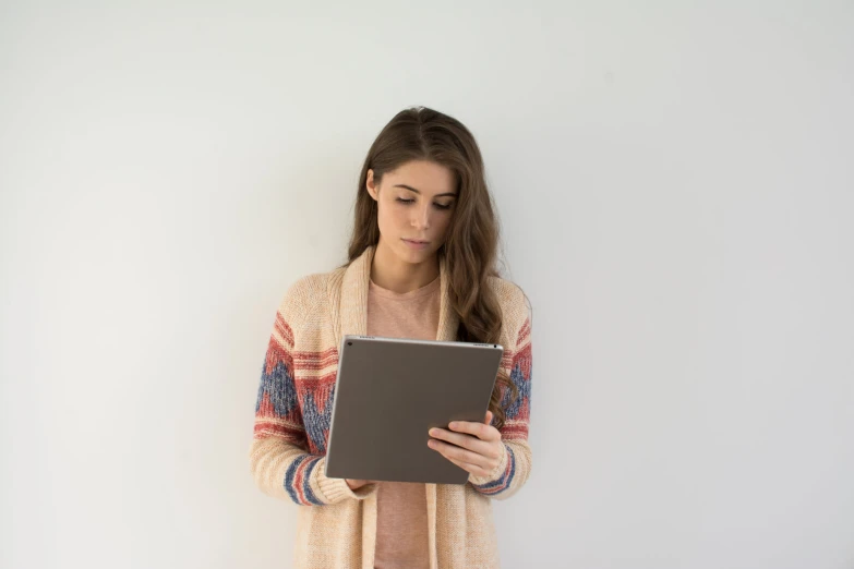 a woman standing and holding an electronic device