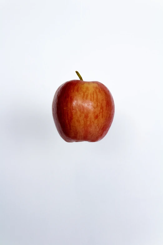 an apple floating on a white background