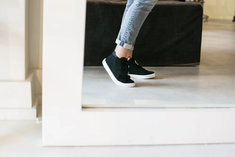 a woman is walking down the stairs with her feet on a table