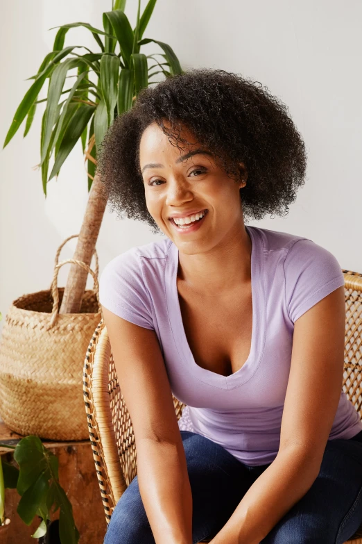 a beautiful woman sitting on top of a chair