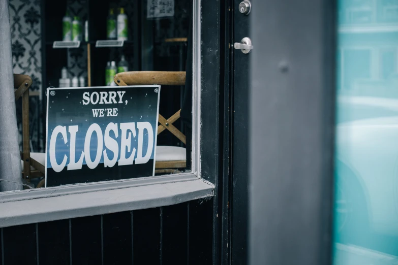 there is a closed sign behind the glass