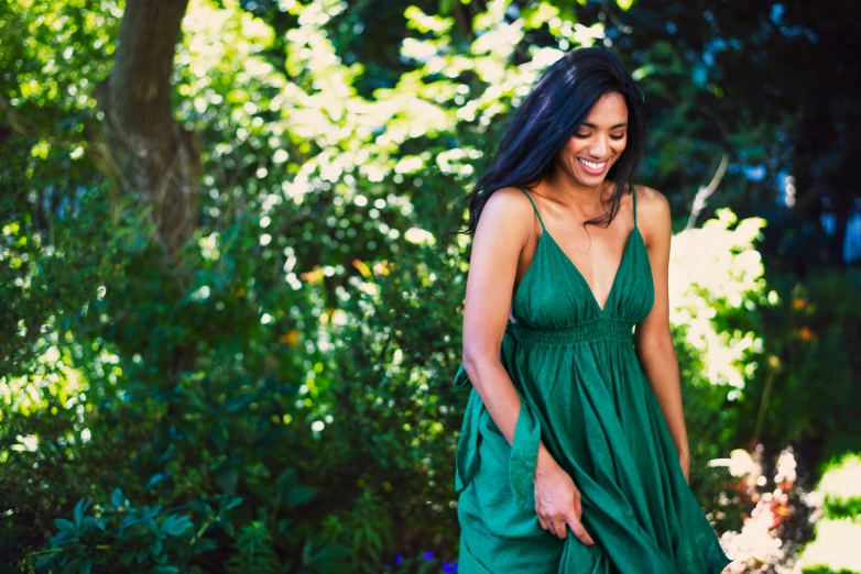 a young woman is in the park and smiling