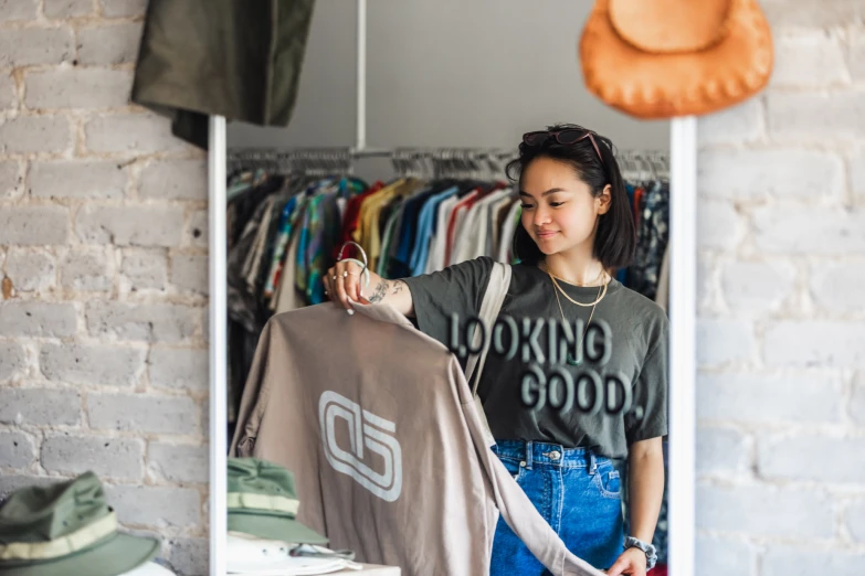 a young woman looking at clothing in a clothing store