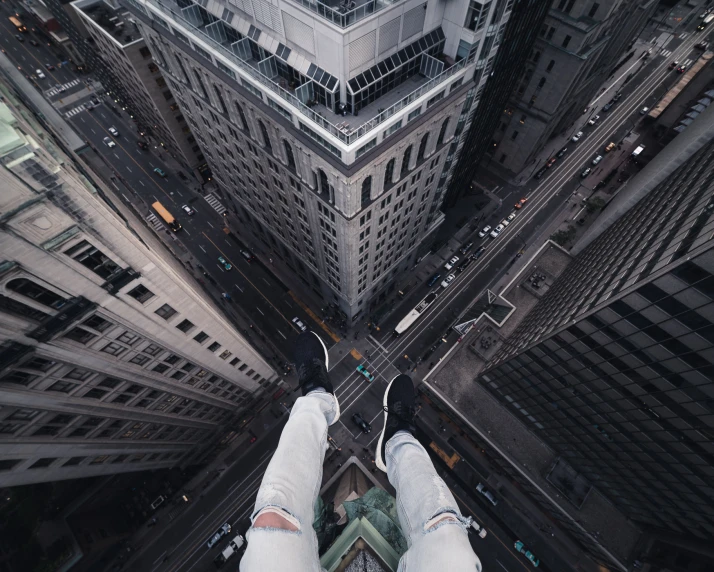 a man is standing above the city skyline