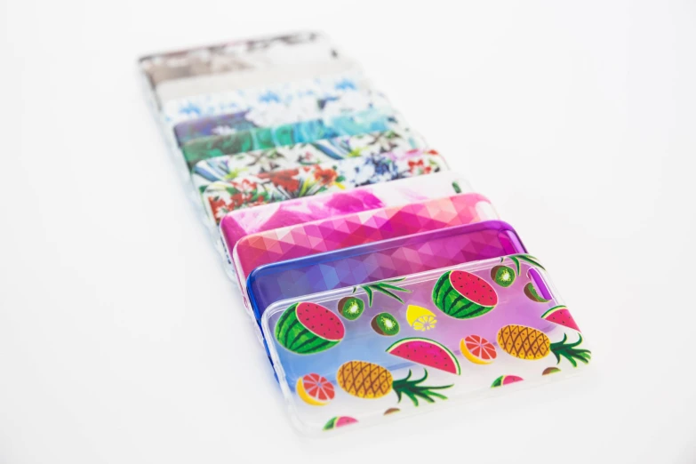 six fruit designed wallets are laying on a table