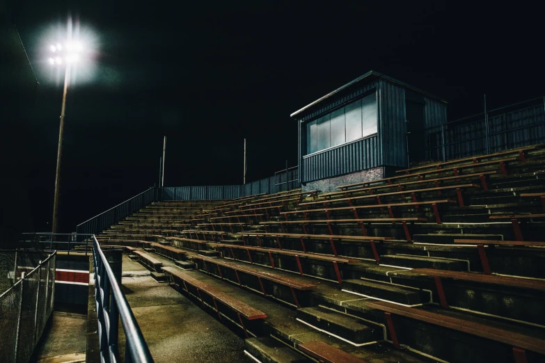 an empty bleachers at night under a light