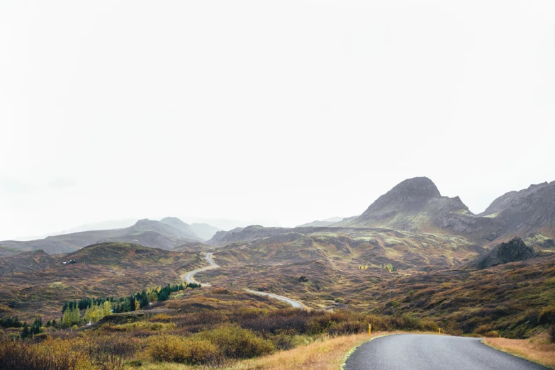 a scenic country road winding through some mountains