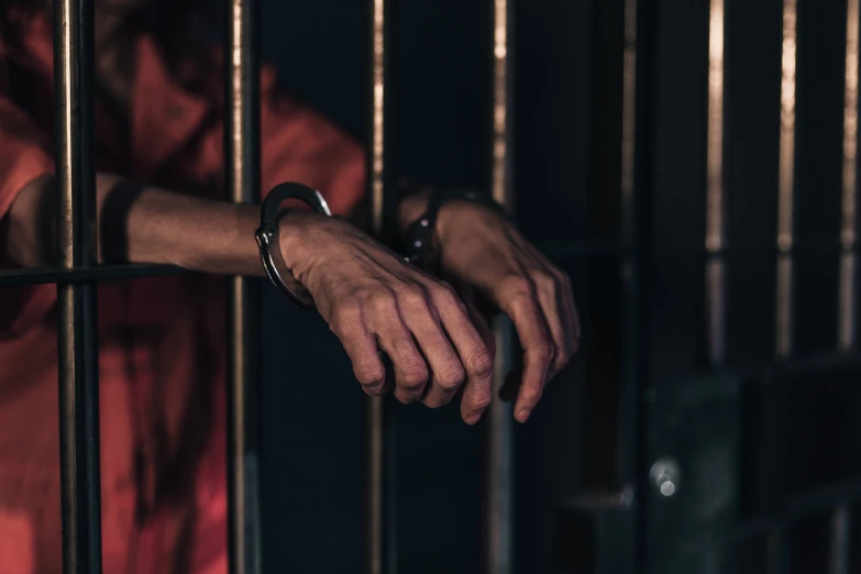 a man in red shirt looking through a  window