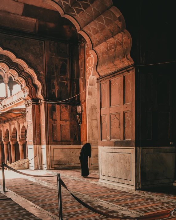 a monk is seen in the open area of an ornate building