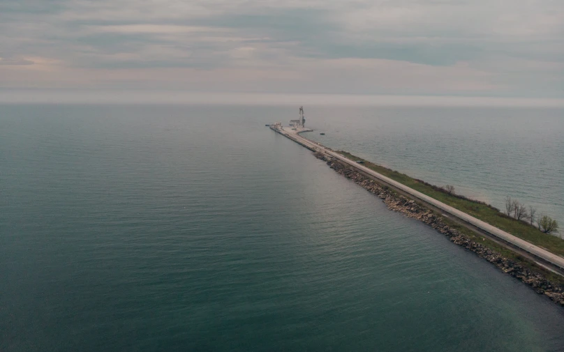 an aerial view of a dock and road along the sea