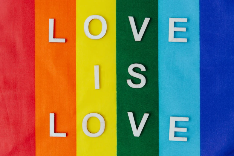 a rainbow colored t - shirt with the words love is love on it