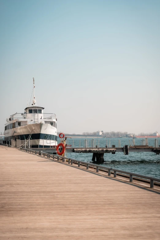 a ferry sits docked in the distance at a pier