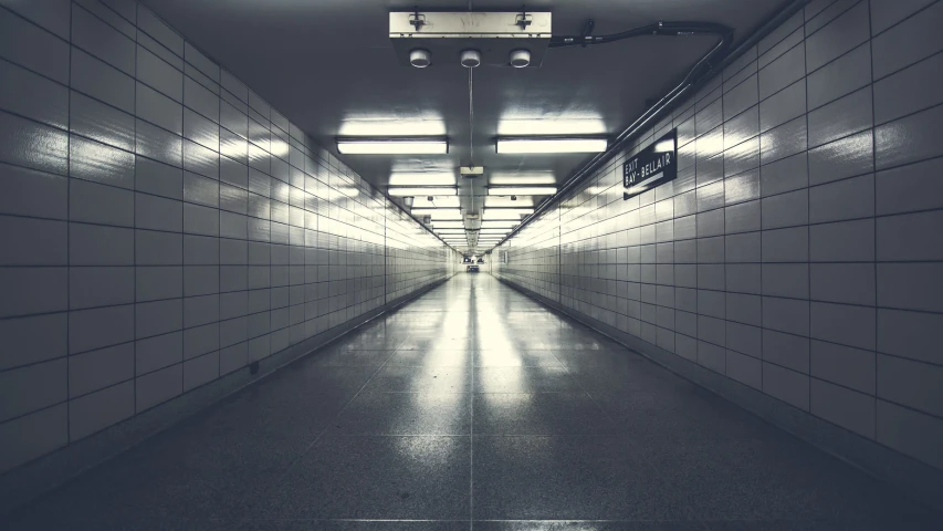 a dark hallway with lots of lights going down the length