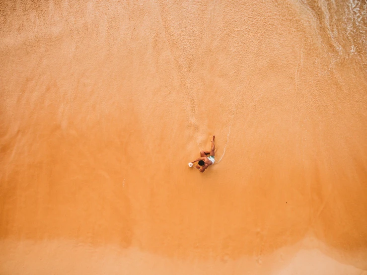 a woman who is swimming in the sand