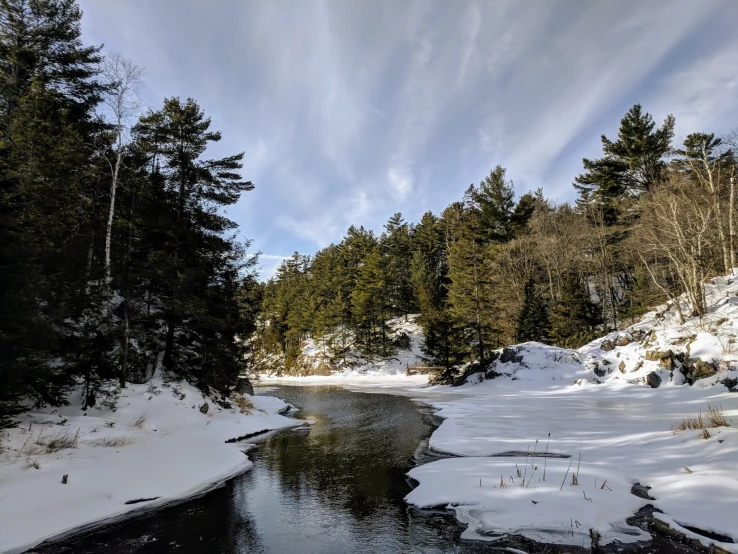 the woods in winter have a deep snow - covered river