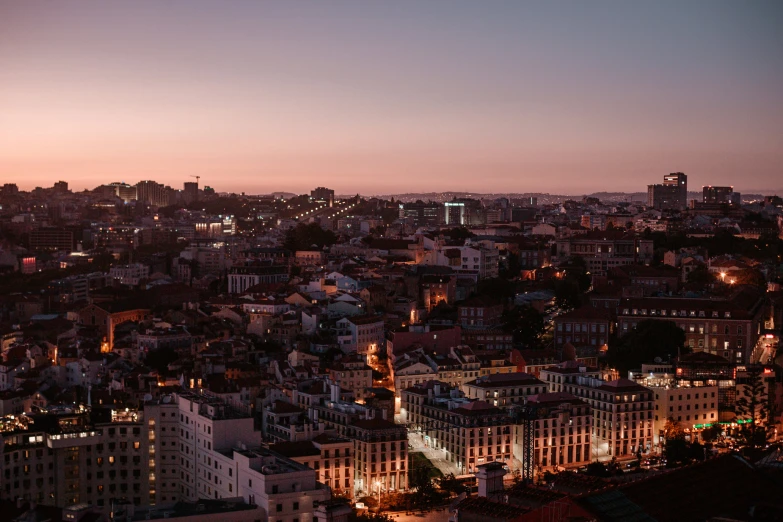 the view of a city at sunset from an observation point