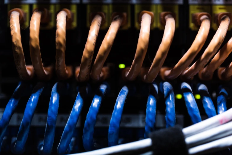 a rack of servers with wires in front of them