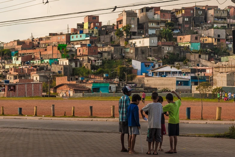 the children are standing on a street corner