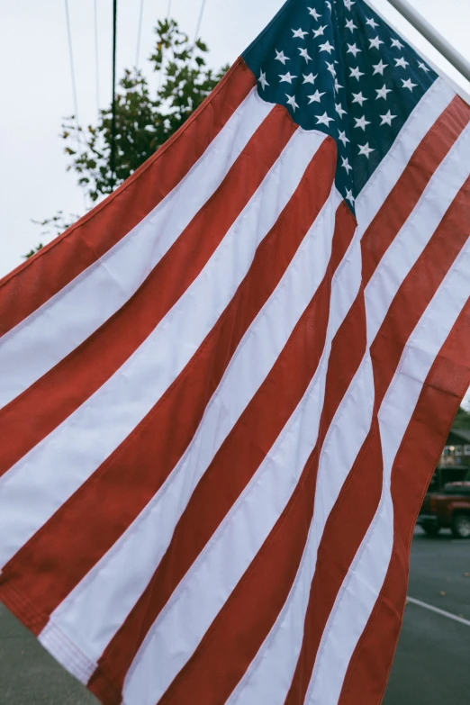 large red white and blue american flag flying on the side of a building