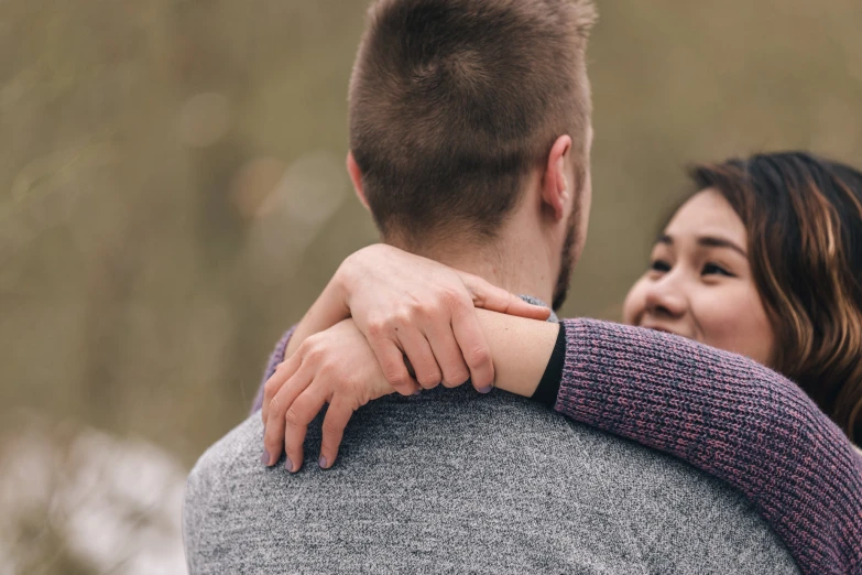 a close up of a couple hugging each other