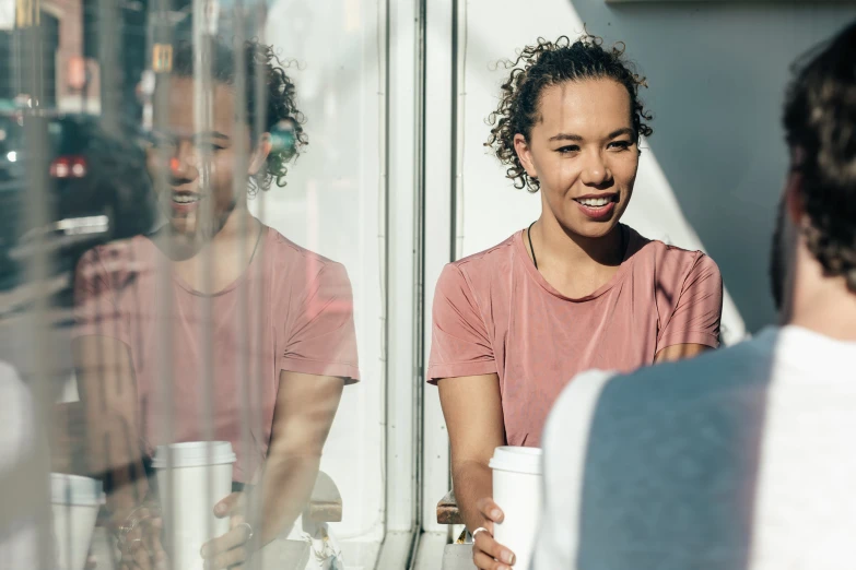 two women standing in front of a glass wall