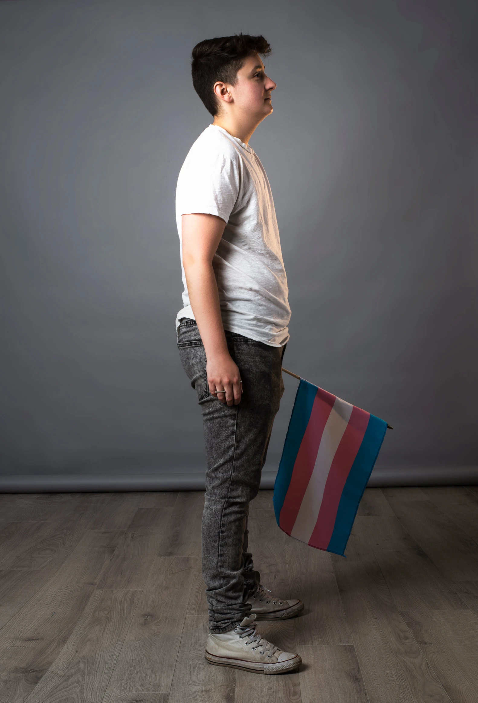 a boy in a white shirt holding a bag