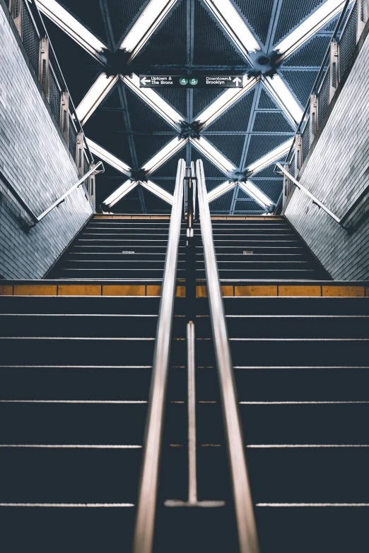 an escalator and some stairs in a public building