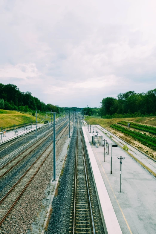 a train yard sitting next to the road and trees