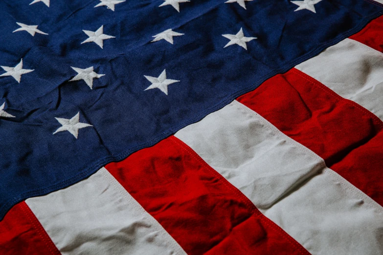 an american flag is lying down in the daytime