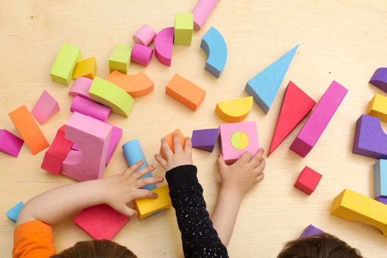 young children trying to match the shape of different shapes with their hands