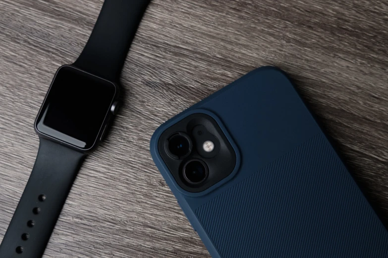 a watch and blue phone sitting next to each other