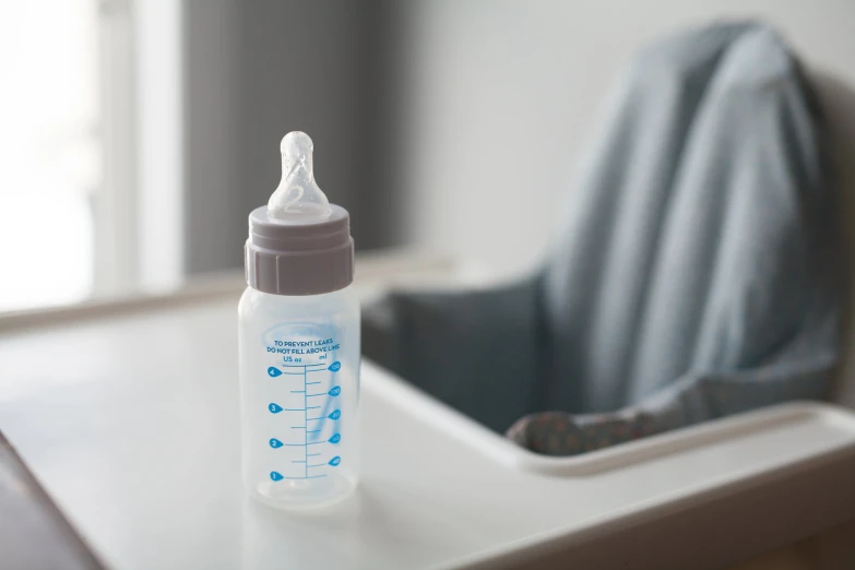 a plastic bottle with a baby's bottle of water in it