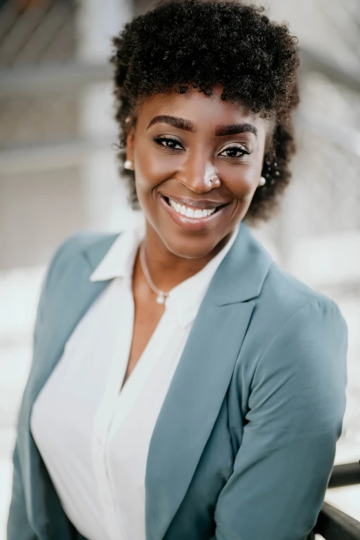 a woman is smiling and looking at the camera