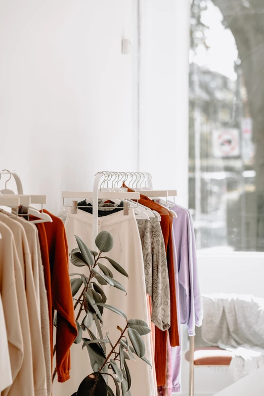 clothing hanging in a store and a chair by it