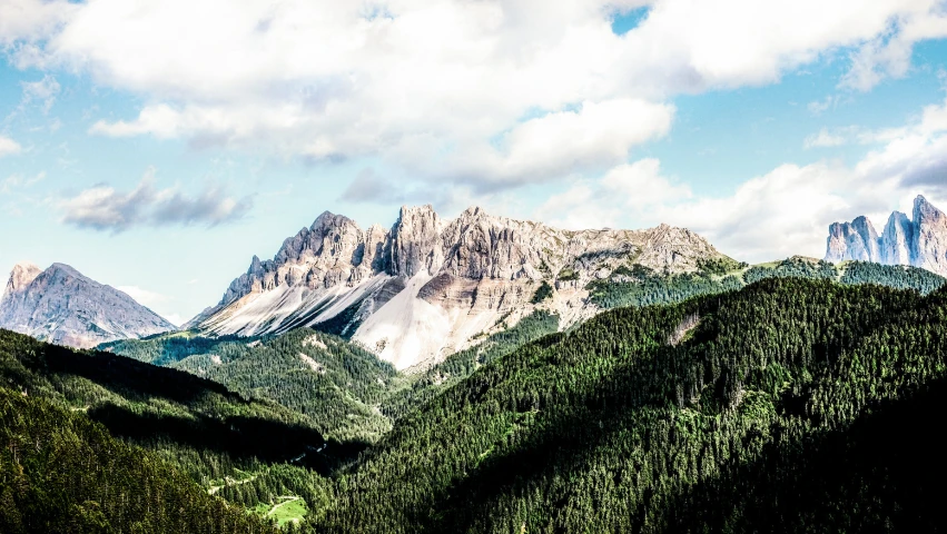 the mountains and trees are seen in the sun