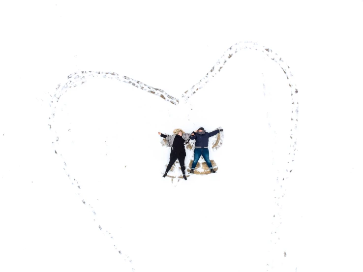 two people are standing together in the snow
