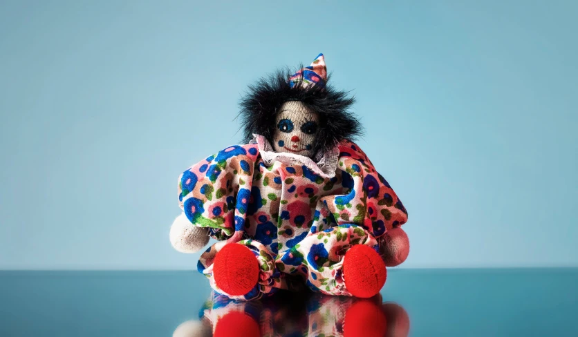 an animal doll dressed in a clown's outfit