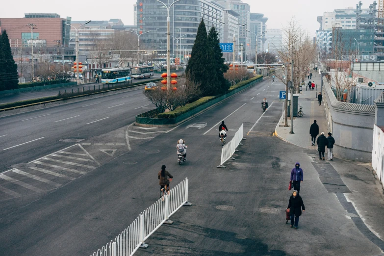 a group of people riding their bikes down a street