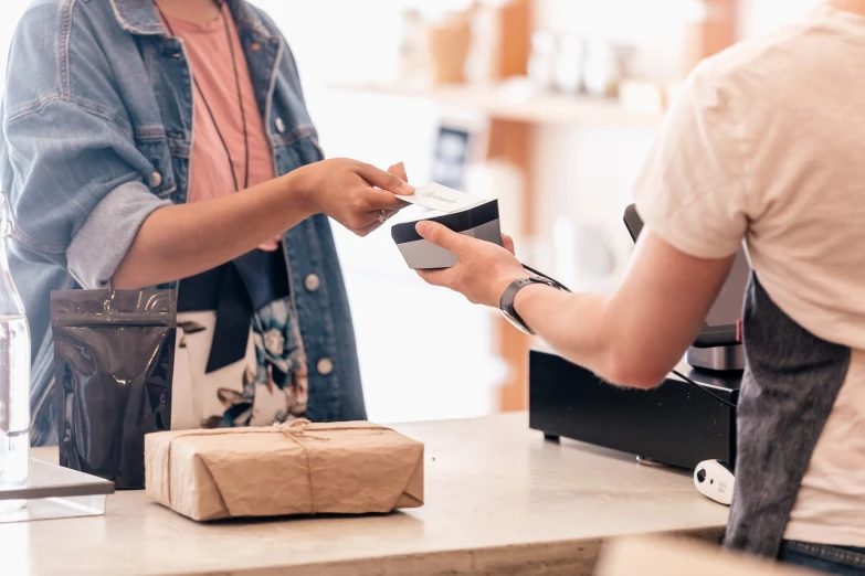 two people working at the counter of a cafe