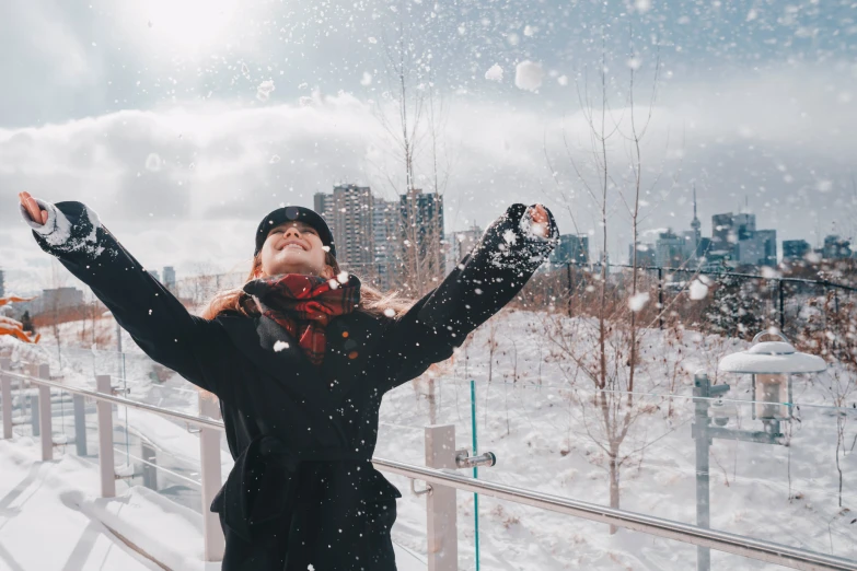 woman standing in front of a railing on snow covered ground