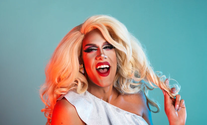 a woman with white makeup holding onto a microphone