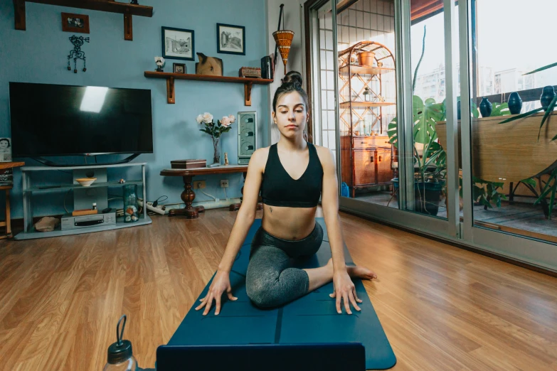 a woman is practicing yoga on an exercise mat