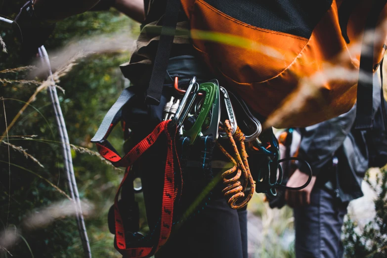 an image of a man carrying his gear while in the woods