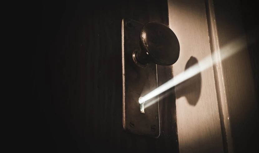 the bright beam from a door handle is seen through the light