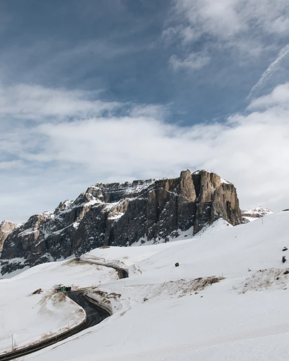 a person riding a snowboard down the side of a snow covered hill